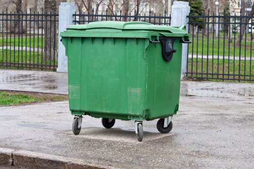 Front view of a commercial waste collection vehicle at a business site